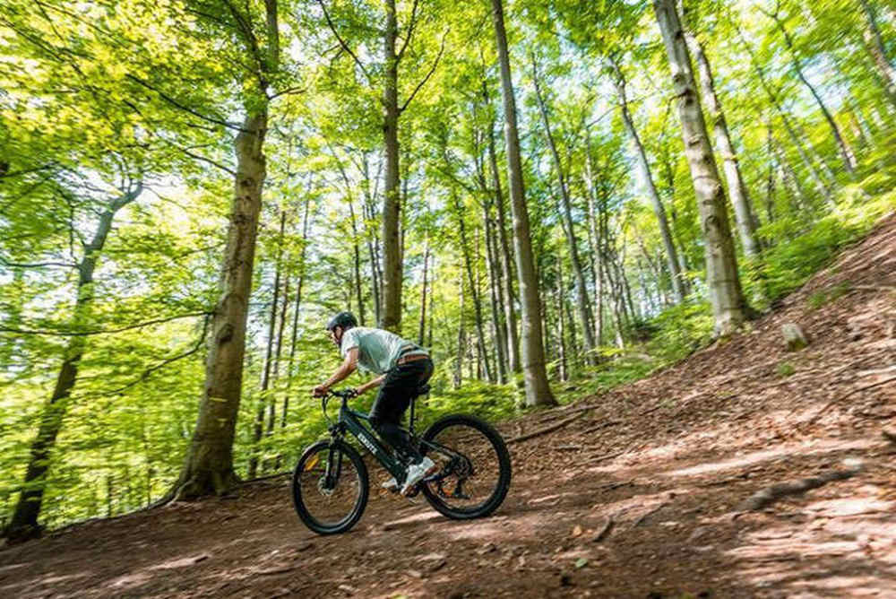 a man goes downhill fast on his derestricted electric bike