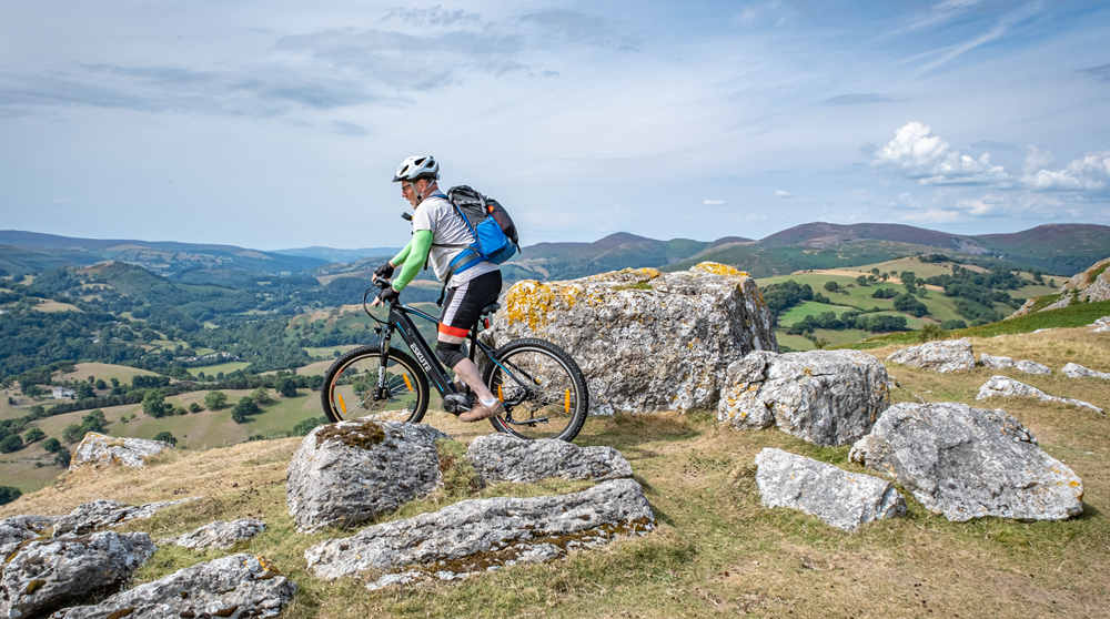 a man is mountain biking with netuno pro electric mountain bike