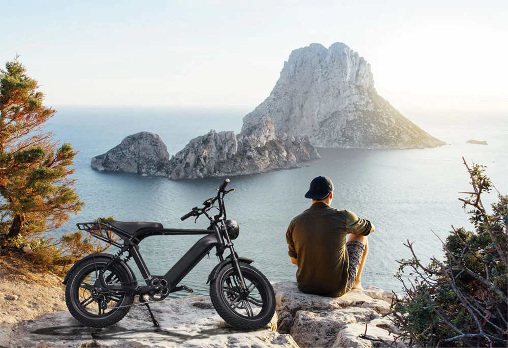 a young man rides his fat e-bike to the lakeside