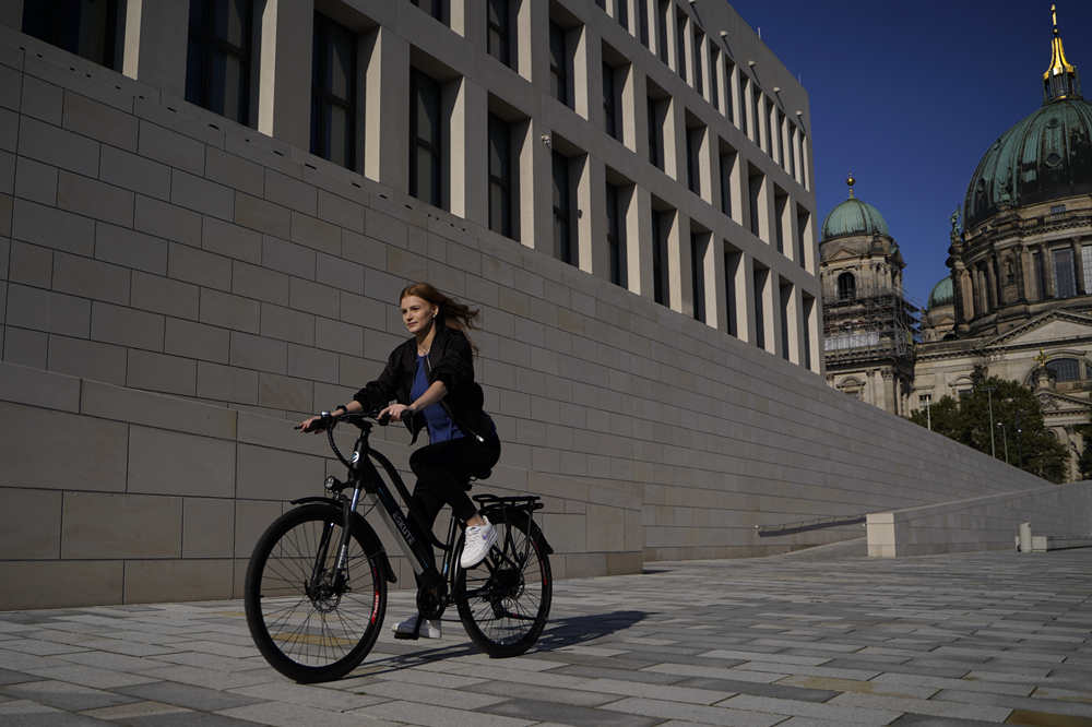 a girl is riding an electric bike with a throttle