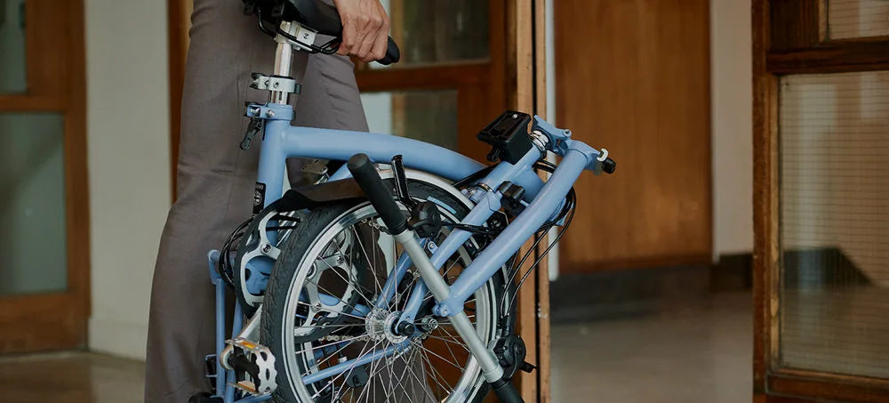 a man holds a folding electric bikes