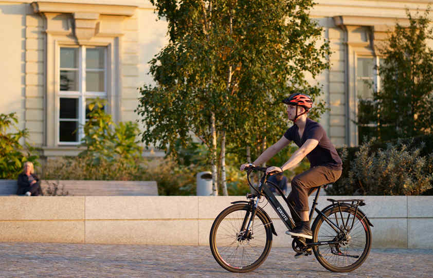 a man with helmet is riding wayfarer ebike in the street