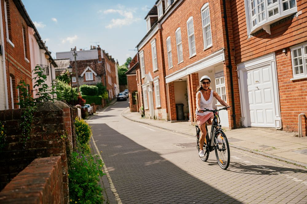 a woman is riding the best electric cruiser bike