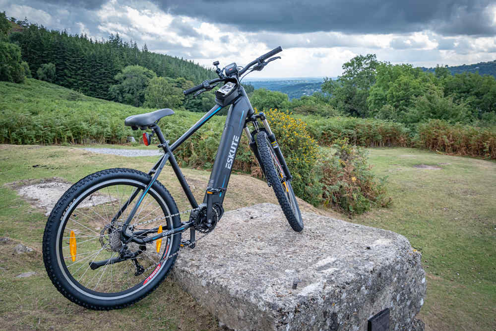 electric mountain bike netuno pro equipped with phone holder bike frame bag stands on the rock