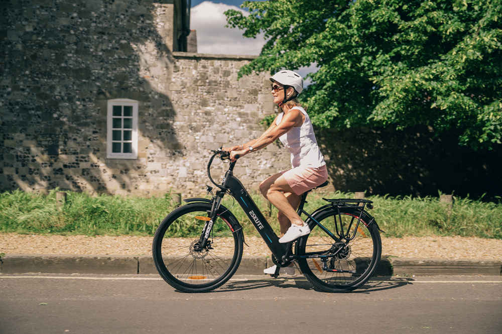 lady with helmet is riding Polluno Electric City Bike