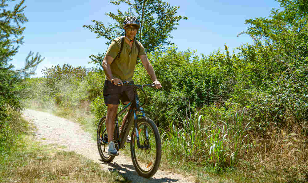 the male rider holds the brake levers tightly on the e-bike