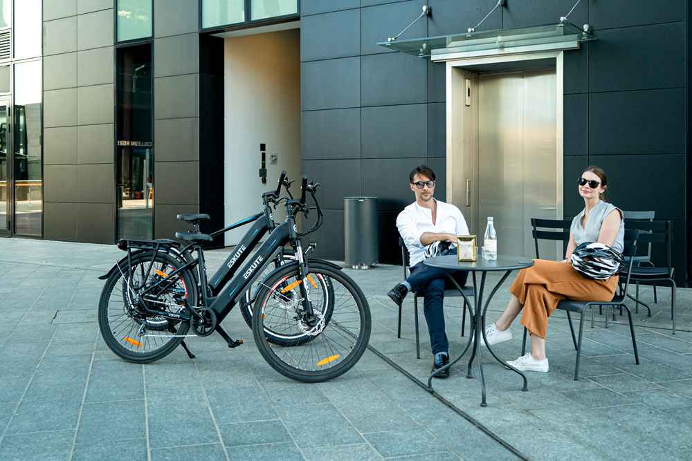a man and a woman ride the best e-bikes for commuting