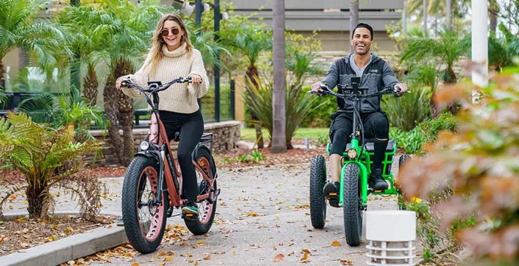 a man rides the electric-trike, and his friend is on an e-bike